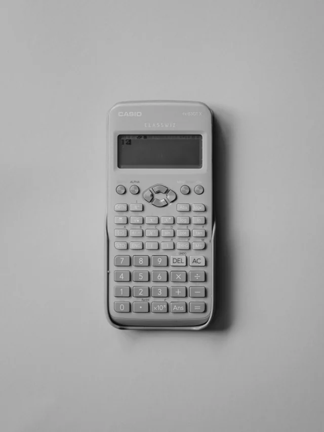 A white calculator on a plain gray background