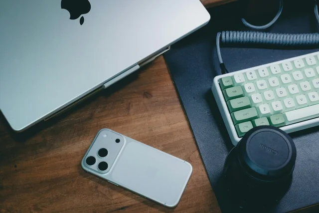 A smartphone and laptop on a desk for online research